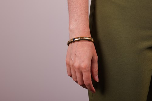 Lot A sapphire and diamond set hinged bangle, set...