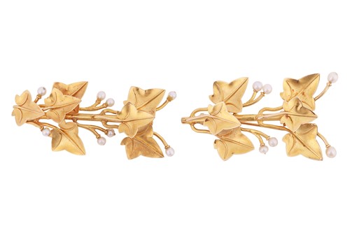 Lot A near pair of leaf brooches, each depicting...