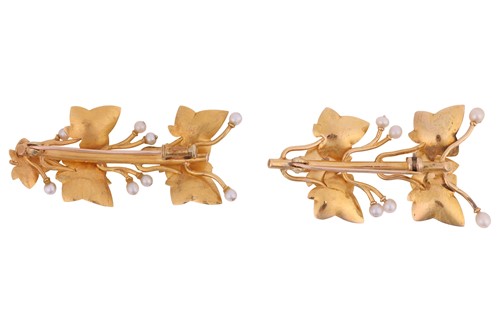 Lot A near pair of leaf brooches, each depicting...
