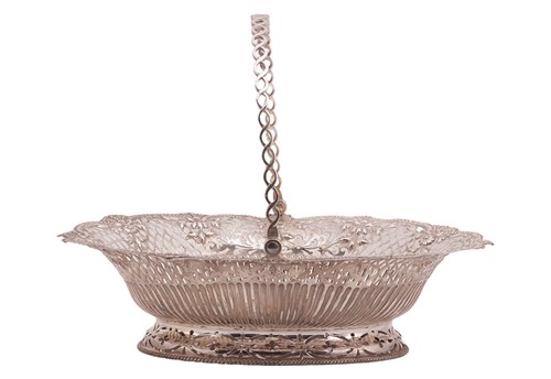 Lot A George III silver cake basket; the oval...