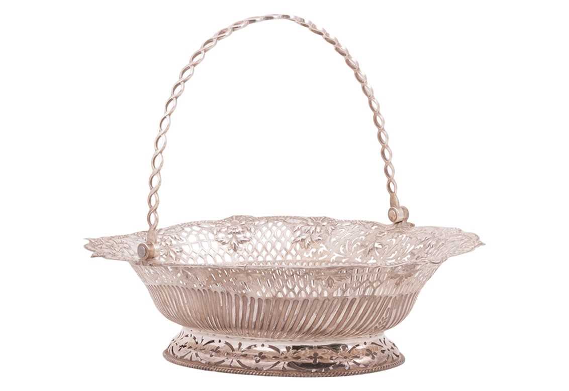 Lot A George III silver cake basket; the oval...