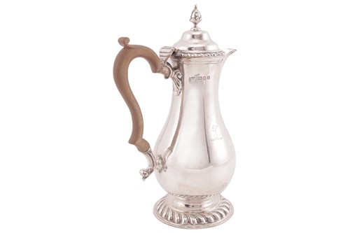 Lot A silver baluster hot water jug of George I...