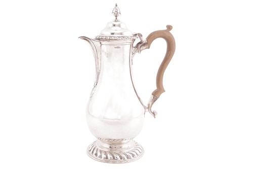 Lot A silver baluster hot water jug of George I...