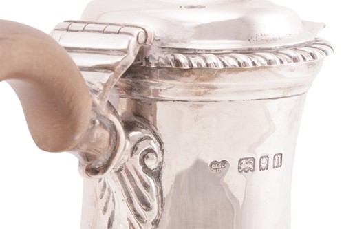 Lot A silver baluster hot water jug of George I...