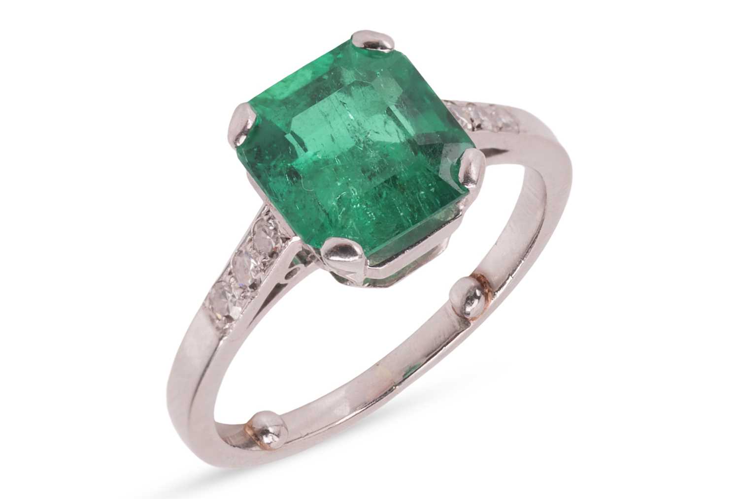Lot A Colombian emerald dress ring, claw-set with...