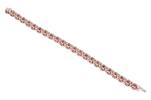 Lot A ruby and diamond line bracelet, set with...