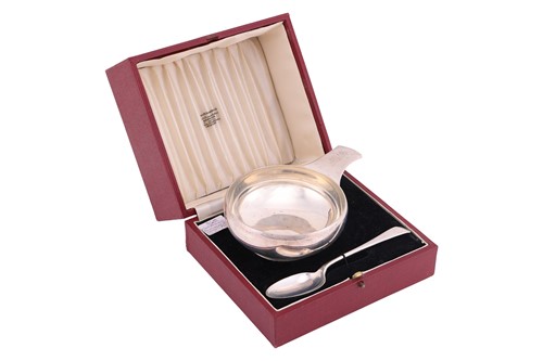 Lot 214 - A cased silver porringer and spoon set, London...