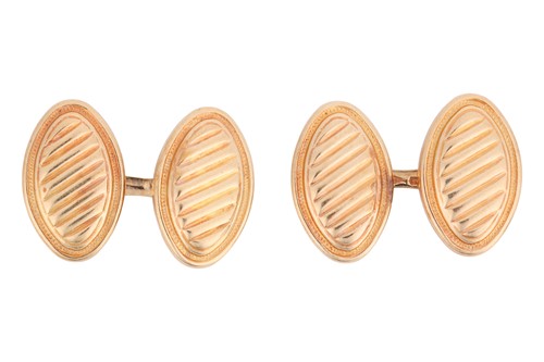 Lot 107 - A pair of oval cufflinks, with diagonal ribbed...