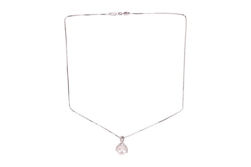 Lot A pearl and diamond pendant and chain, the...