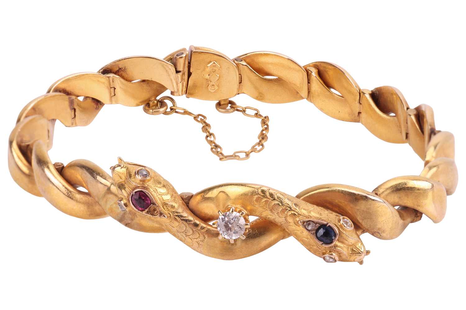 Lot A gem-set double snake head bracelet, hinged...