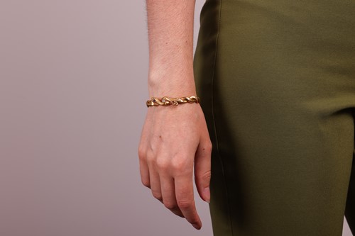 Lot 11 - A gem-set double snake head bracelet, hinged...
