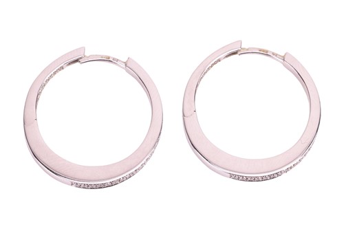 Lot A pair of diamond hoop earrings, set to the...