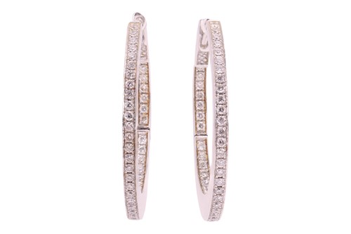 Lot A pair of diamond hoop earrings, set to the...