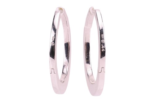 Lot A pair of diamond hoop earrings, set to the...