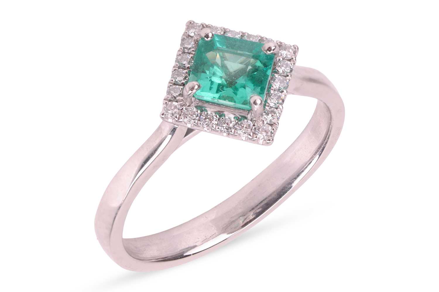 Lot An emerald and diamond ring, featuring a...