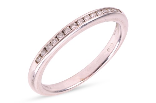 Lot A diamond half eternity ring, set with round...