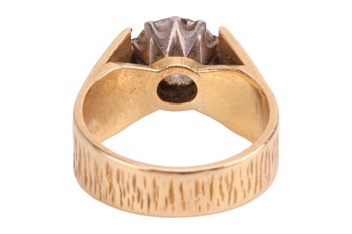 Lot A single stone diamond ring, featuring a round...