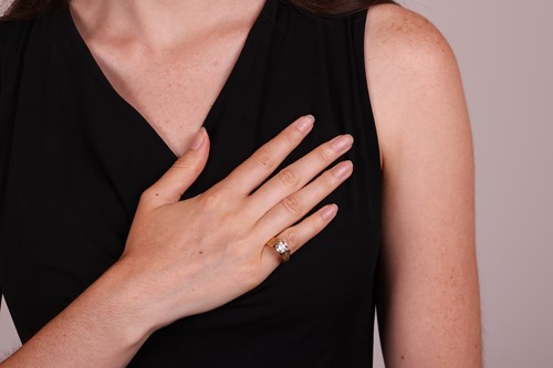 Lot A single stone diamond ring, featuring a round...