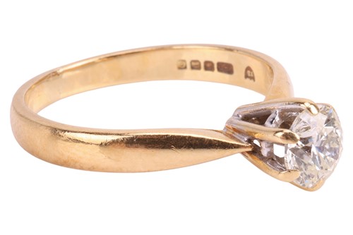 Lot A diamond solitaire ring, featuring a claw-set...