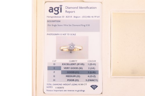 Lot A diamond solitaire ring, featuring a claw-set...