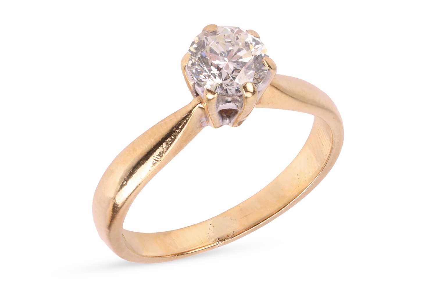 Lot A diamond solitaire ring, featuring a claw-set...