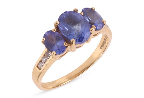 Lot A tanzanite and diamond ring, set with three...