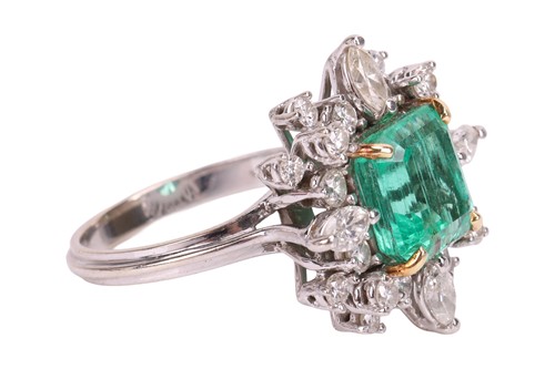 Lot 103 - An emerald & diamond cluster ring, the ring...