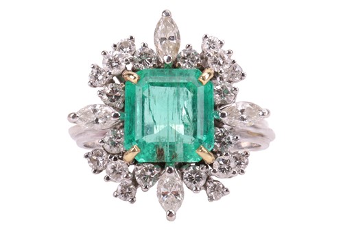 Lot 103 - An emerald & diamond cluster ring, the ring...