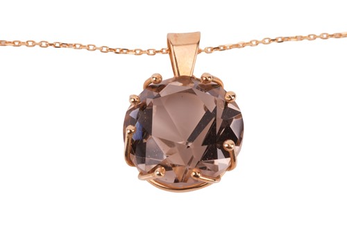 Lot 57 - A smoky quartz pendant on chain, claw-set with...