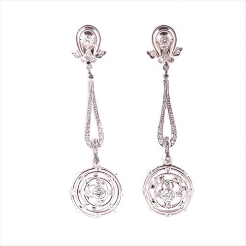 Lot 694 - A pair of diamond drop earrings each with a...
