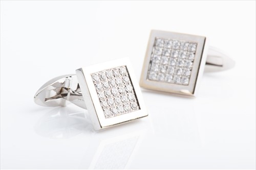 Lot 430 - A pair of diamond cuff links the square mounts...