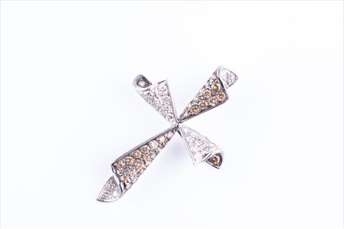 Lot 540 - A white and cognac diamond cross pave set with...