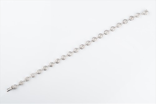 Lot 497 - A diamond cluster line bracelet the circular...