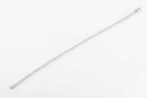 Lot 502 - A diamond line bracelet set with round...